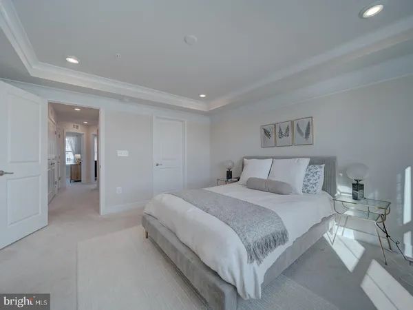 a bedroom with a bed and painting on the wall
