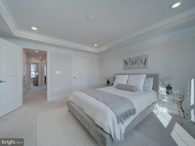 a bedroom with a bed and painting on the wall