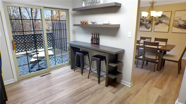 a dining room with furniture and wooden floor