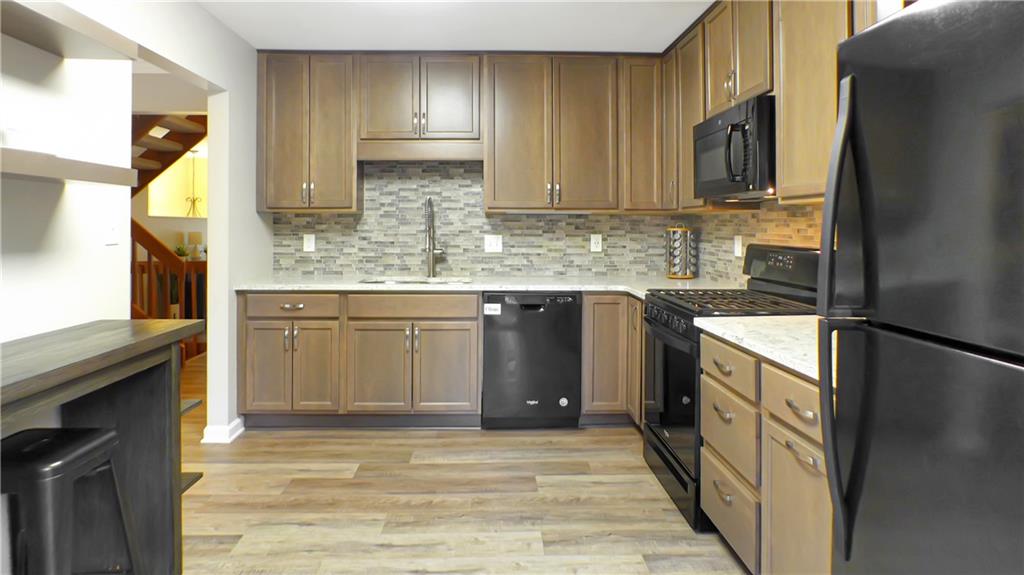 130 Terra Drive McKees Rocks, PA 15136 - Photo 15 of 38 a kitchen with stainless steel appliances granite countertop a sink stove and refrigerator