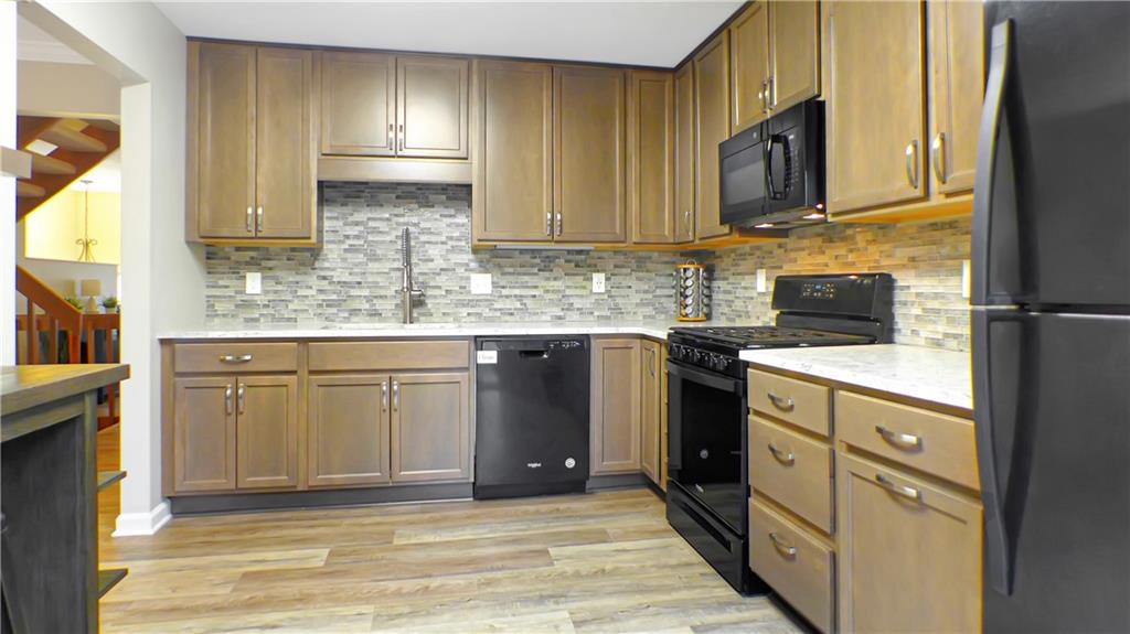 130 Terra Drive McKees Rocks, PA 15136 - Photo 16 of 38 a kitchen with stainless steel appliances granite countertop a stove a sink and a microwave