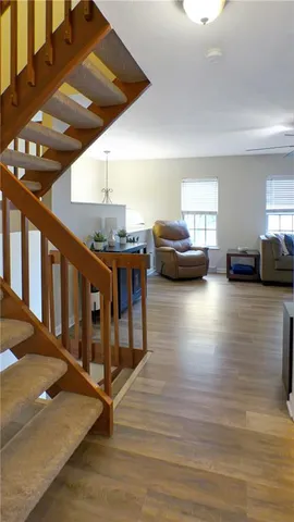a view of entryway livingroom and hall with wooden floor