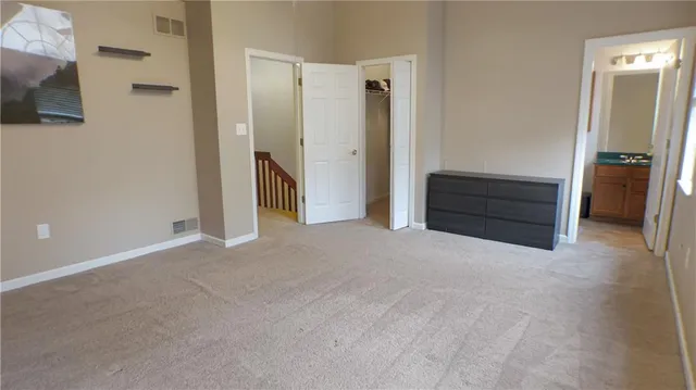 a view of an empty room with closet area