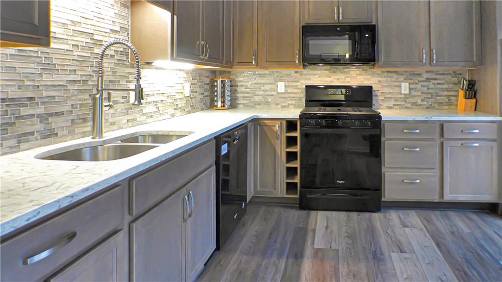 130 Terra Drive McKees Rocks, PA 15136 - Photo 27 of 38 a kitchen with a sink a stove and cabinets