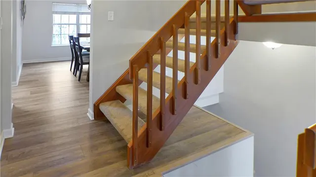 a view of entryway and hall with wooden floor