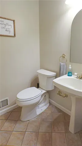 a white toilet sitting next to a bathroom sink