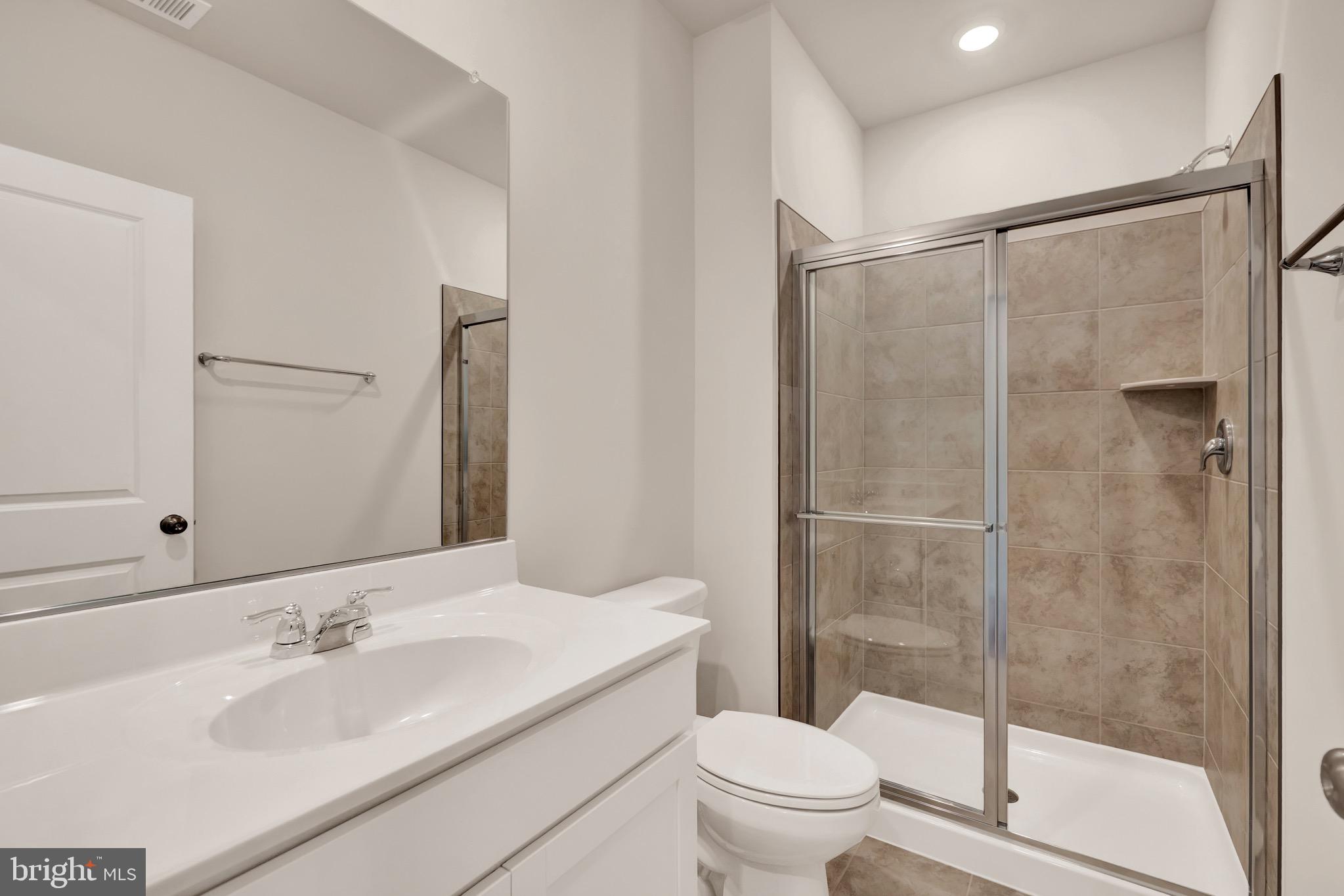 614 Mountain Laurel Boulevard Ranson, WV 25438 - Photo 26 of 28 a bathroom with a sink and a mirror