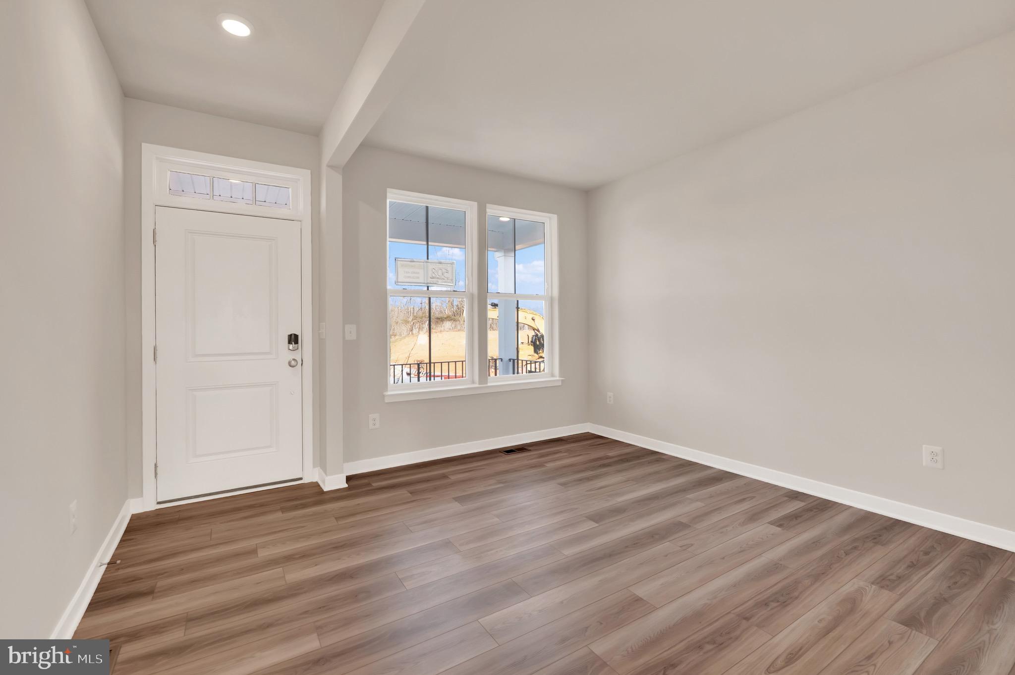 614 Mountain Laurel Boulevard Ranson, WV 25438 - Photo 4 of 28 a view of an empty room with wooden floor and a window