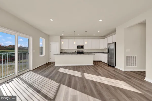 a view of a kitchen with wooden floor