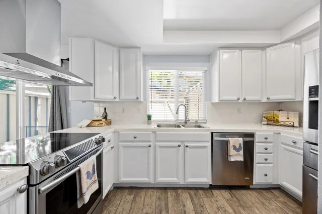 a kitchen with appliances cabinets and a window