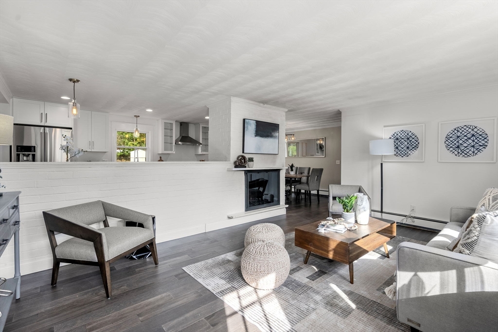 a living room with furniture and a kitchen view