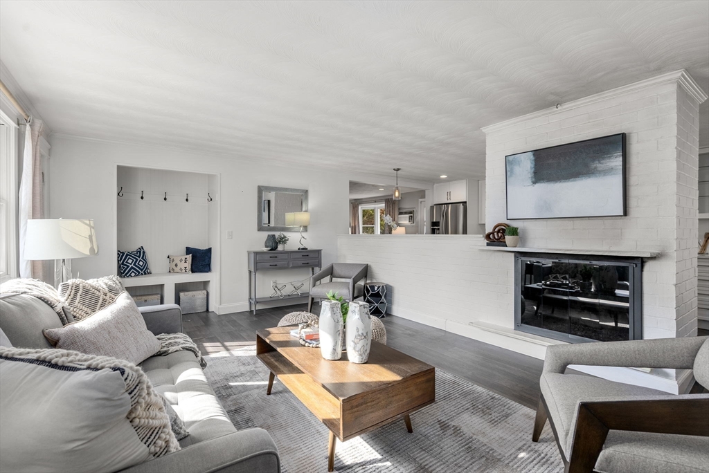 62 Gregory Road Framingham, MA 01701 - Photo 2 of 24 a living room with furniture a flat screen tv and a fireplace