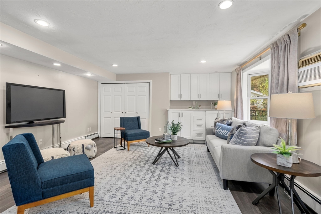 62 Gregory Road Framingham, MA 01701 - Photo 9 of 24 a living room with furniture and a flat screen tv