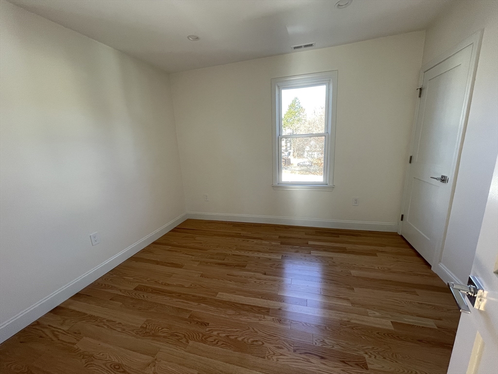 97 Phillips Street, Unit 3 Methuen, MA 01844 - Photo 8 of 9 a view of empty room with wooden floor and fan