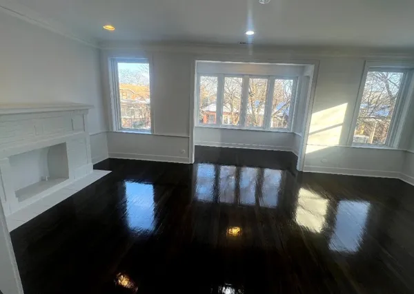 a view of a livingroom with furniture hardwood floor and staircase