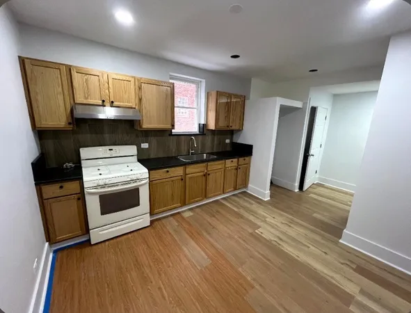 a kitchen with a sink a refrigerator and window