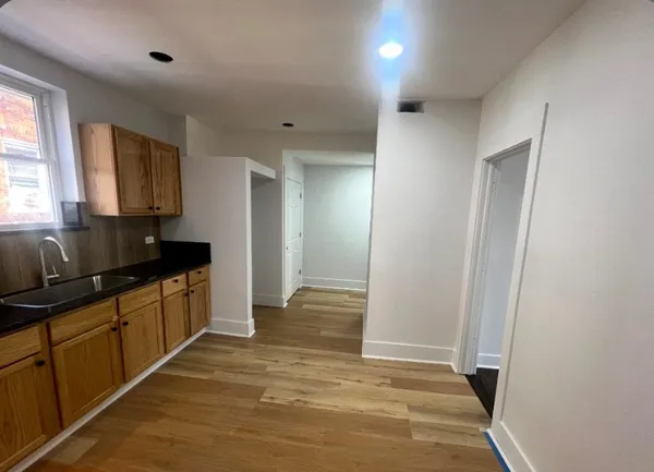 a kitchen with granite countertop a refrigerator and a sink