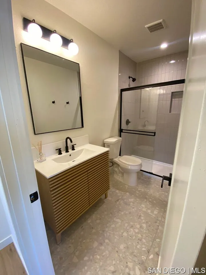 4455 Illinois Street, Unit B San Diego, CA 92116 - Photo 2 of 10 a bathroom with a sink toilet and mirror