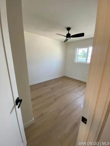 an empty room with wooden floor
