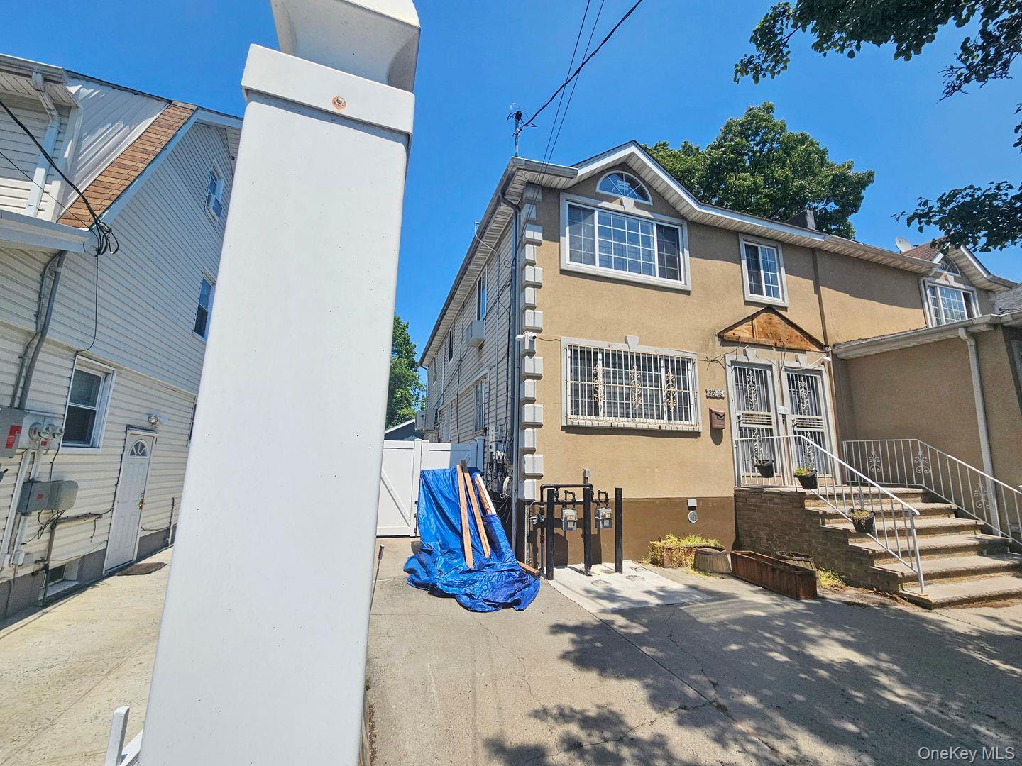219-19 143rd Road Queens, NY 11413 - Photo 3 of 4 a view of a house with a patio