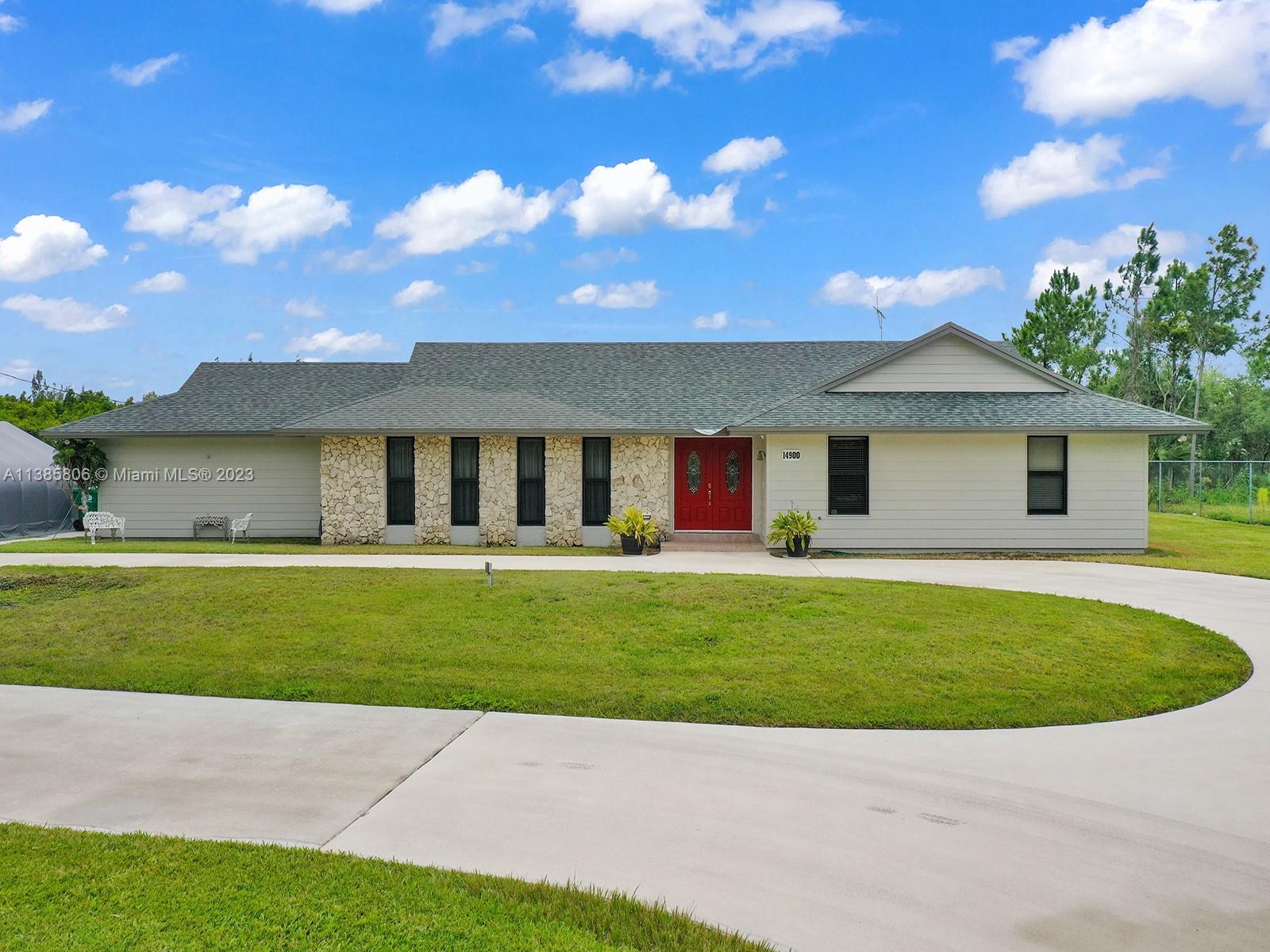 a view of a house with a backyard