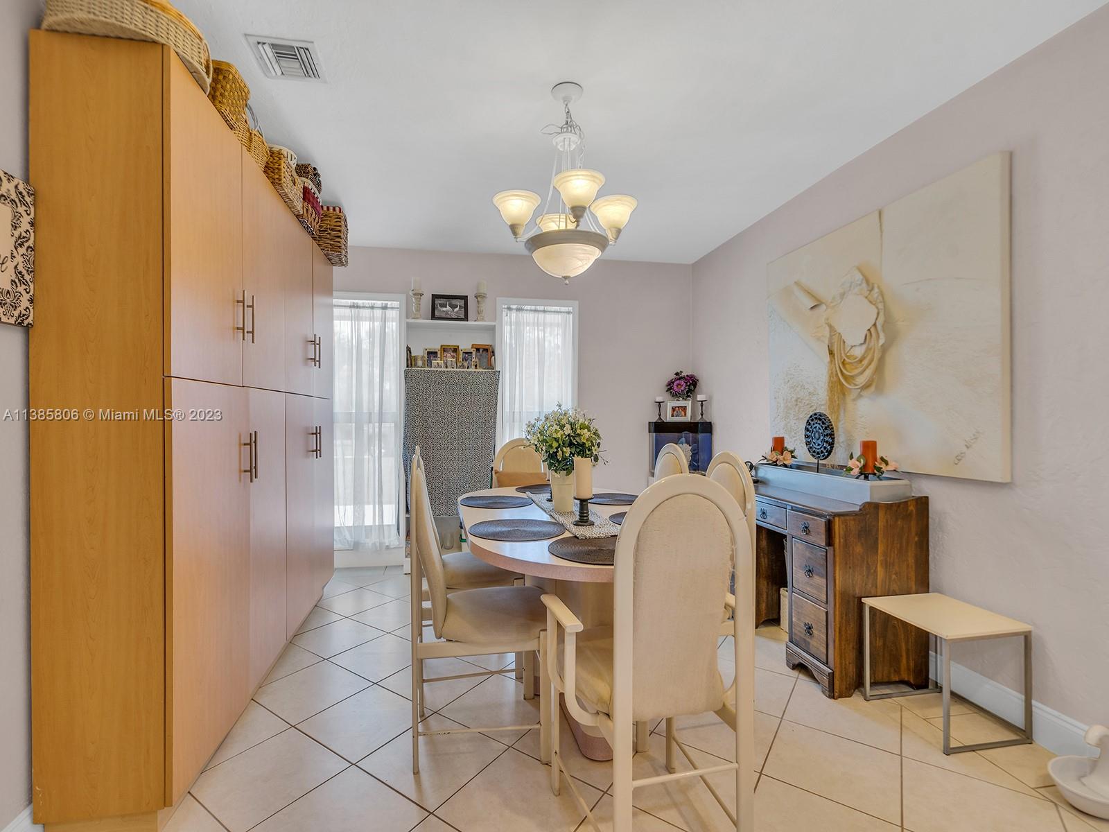 14900 Southwest 250th Street Homestead, FL 33032 - Photo 11 of 34 a dining room with furniture and chandelier
