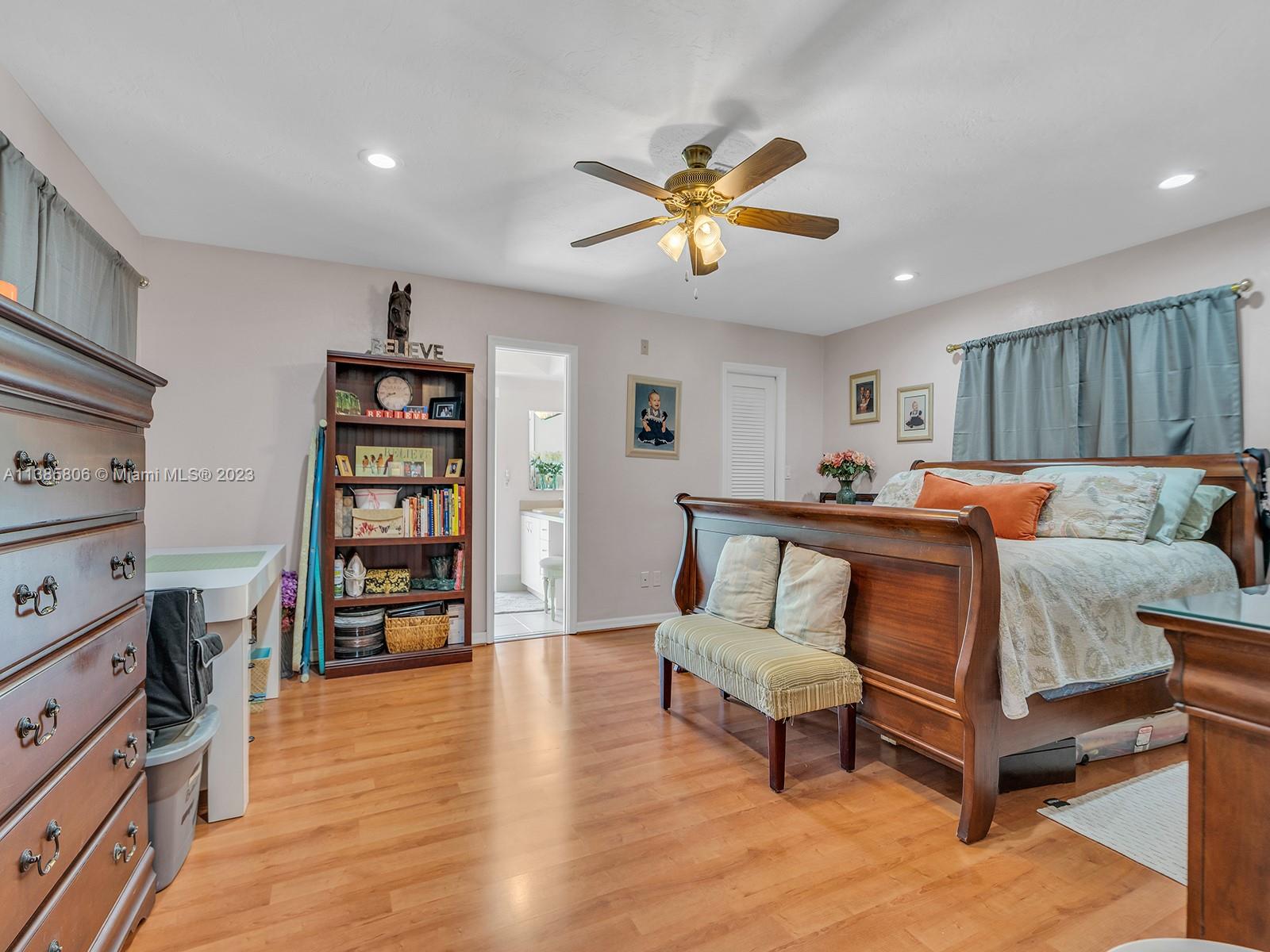 14900 Southwest 250th Street Homestead, FL 33032 - Photo 13 of 34 a bedroom with furniture and a book shelf