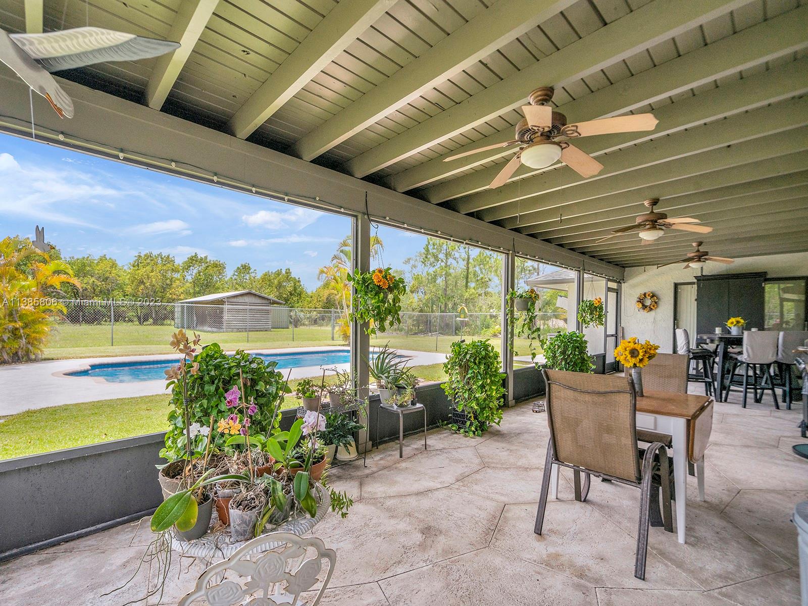 14900 Southwest 250th Street Homestead, FL 33032 - Photo 20 of 34 a dining room with furniture and a garden view