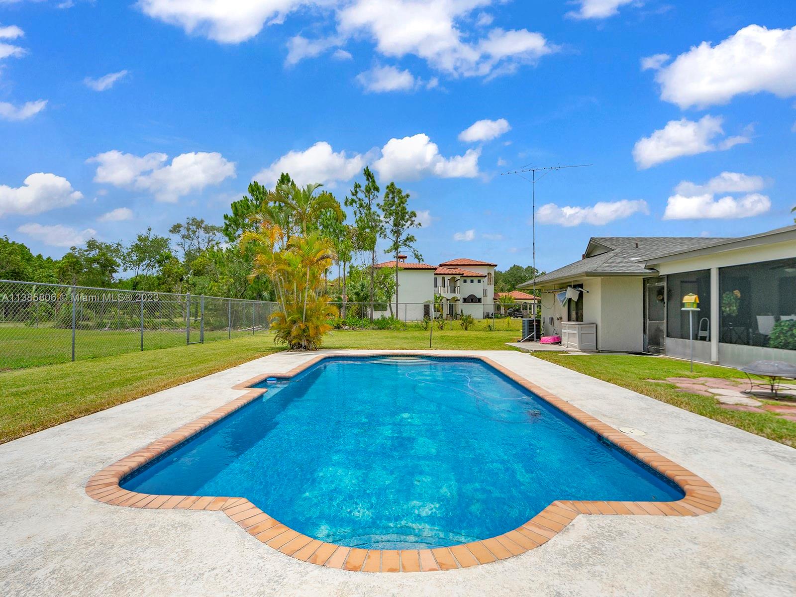 14900 Southwest 250th Street Homestead, FL 33032 - Photo 2 of 34 a view of a house with swimming pool and yard