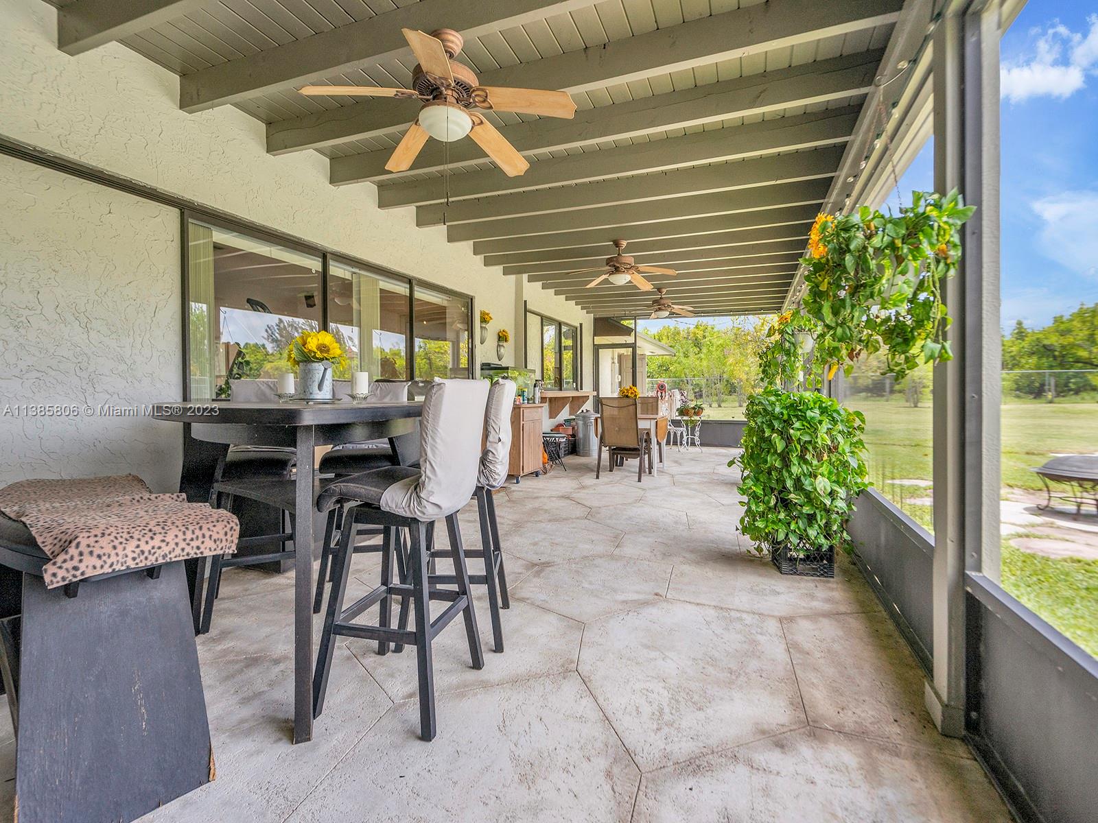 14900 Southwest 250th Street Homestead, FL 33032 - Photo 22 of 34 a view of a patio with a table and chairs and potted plants