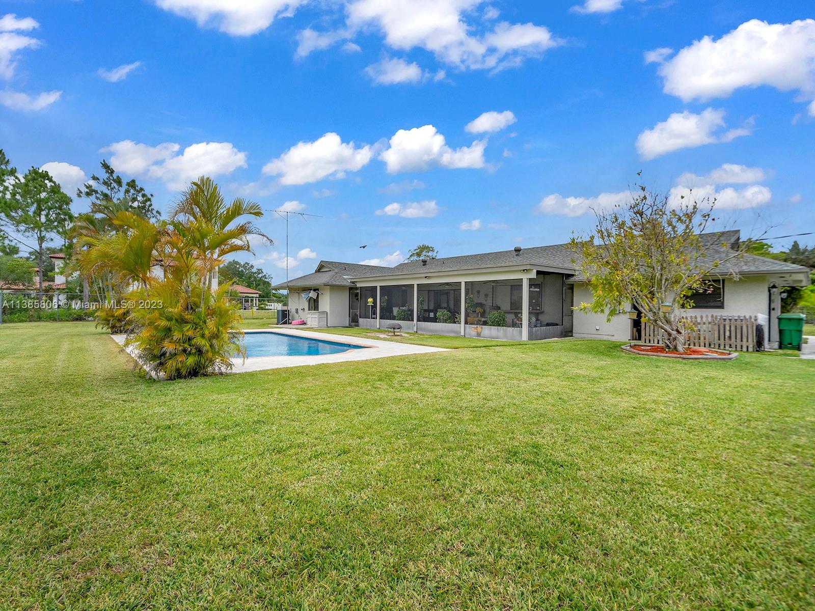 14900 Southwest 250th Street Homestead, FL 33032 - Photo 25 of 34 a front view of a house with a garden