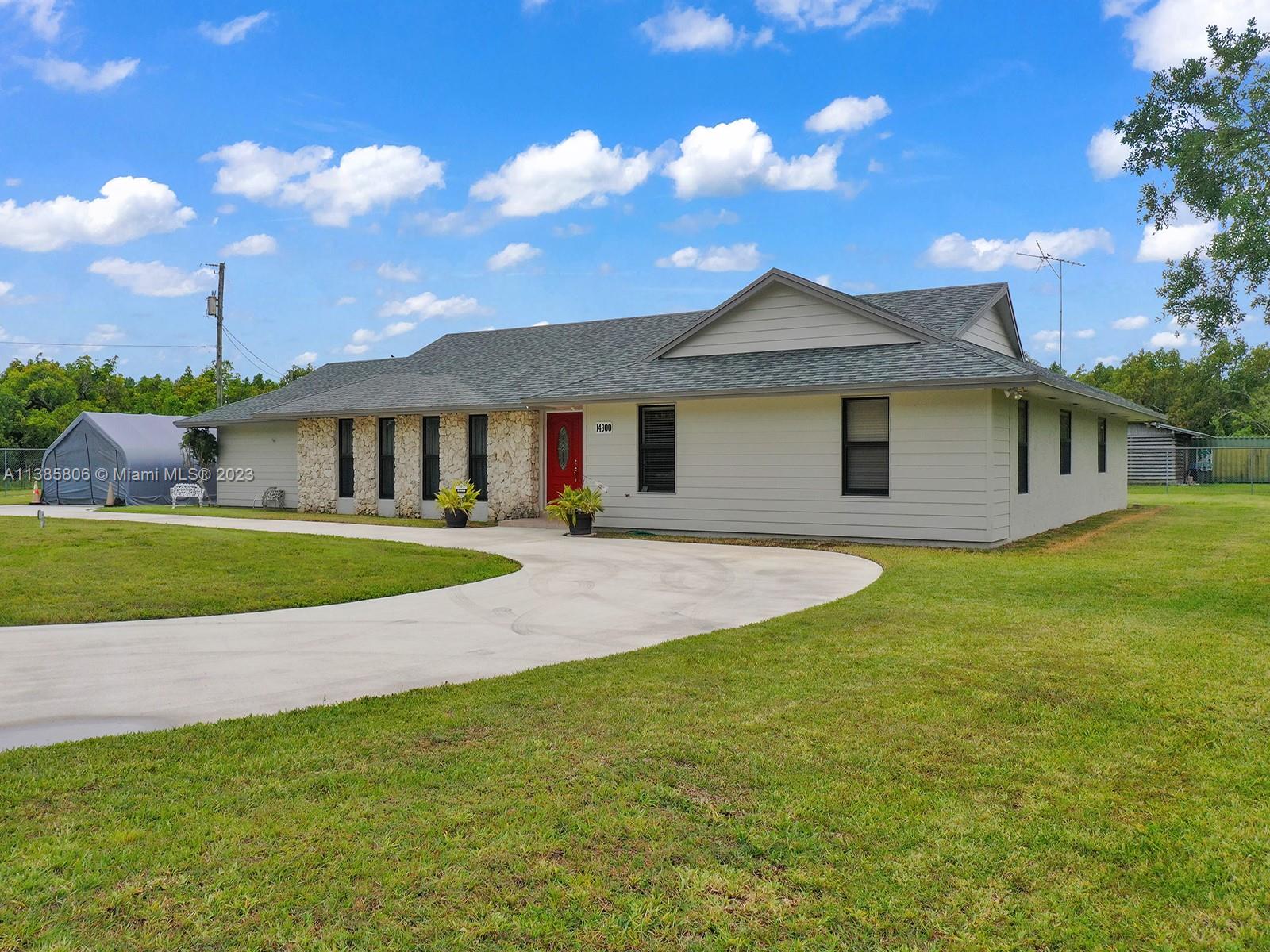 14900 Southwest 250th Street Homestead, FL 33032 - Photo 27 of 34 a view of a house with a big yard