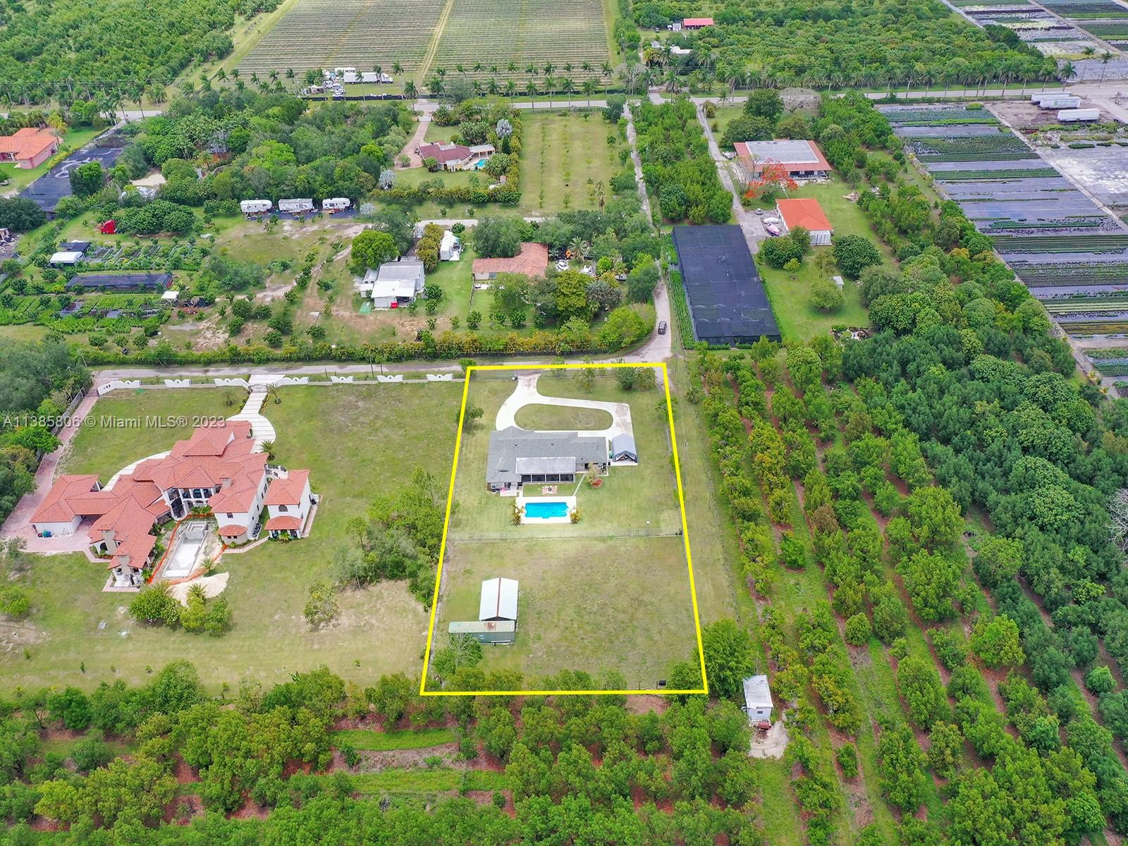 14900 Southwest 250th Street Homestead, FL 33032 - Photo 30 of 34 a aerial view of a house with a yard and lake view