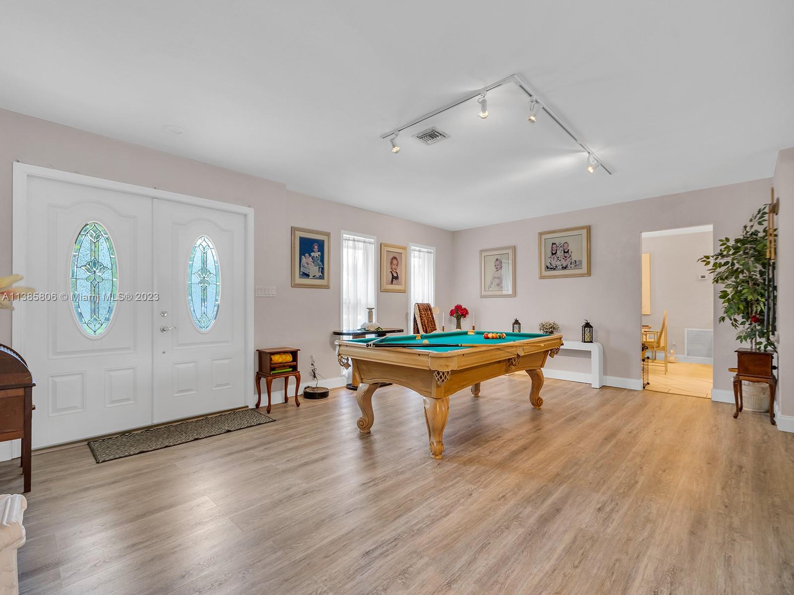 14900 Southwest 250th Street Homestead, FL 33032 - Photo 3 of 34 a room with wooden floor and furniture