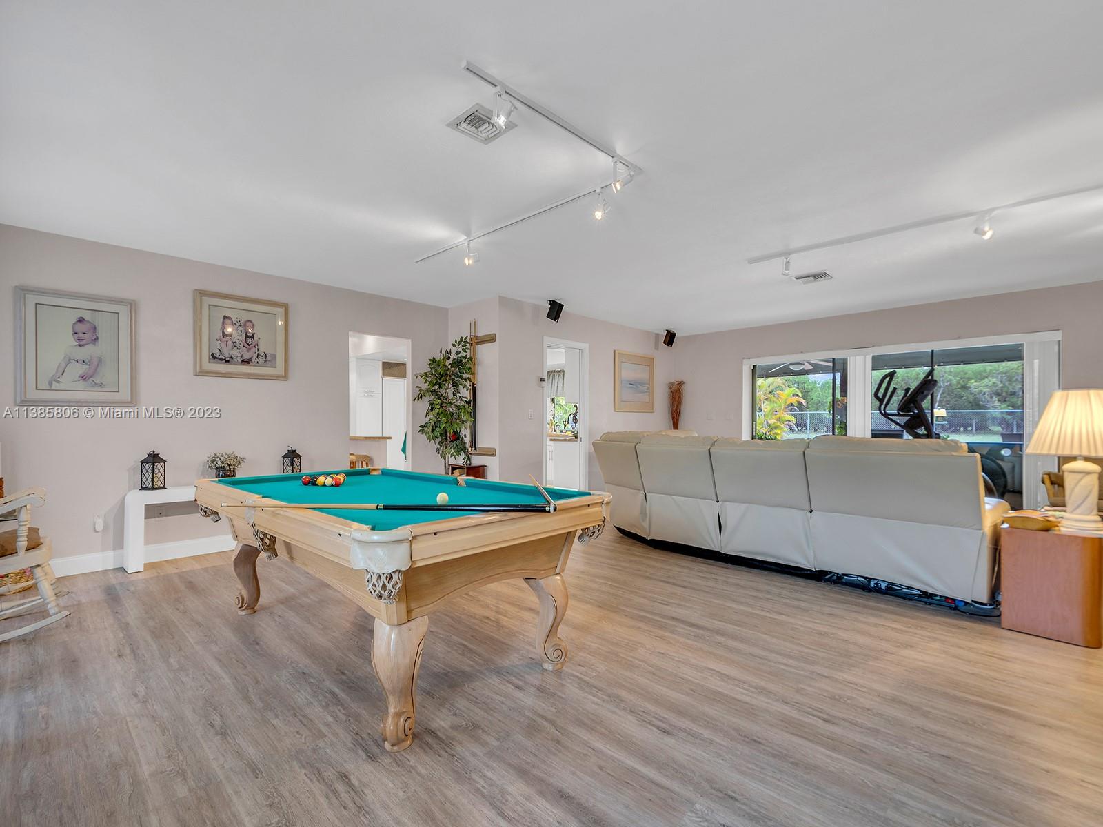14900 Southwest 250th Street Homestead, FL 33032 - Photo 4 of 34 a living room with furniture and a wooden floor