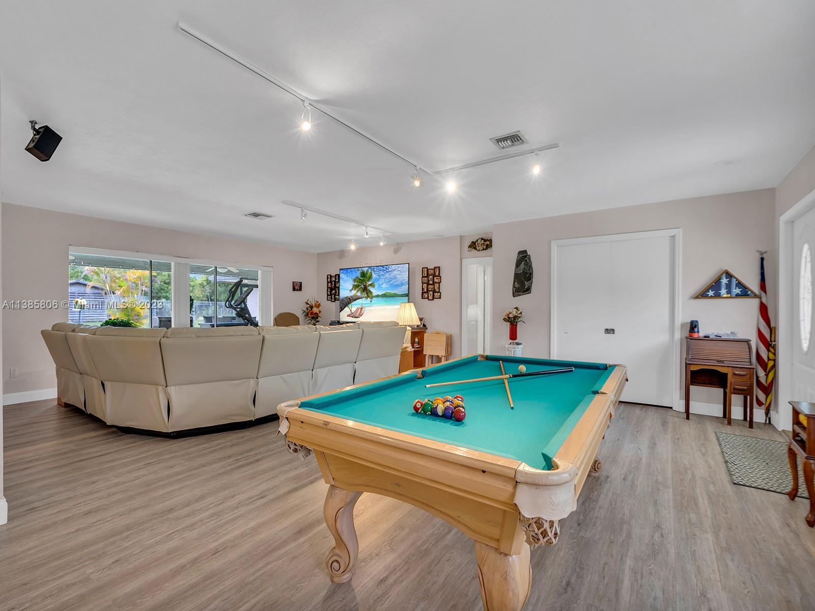 14900 Southwest 250th Street Homestead, FL 33032 - Photo 6 of 34 a living room with furniture and a flat screen tv