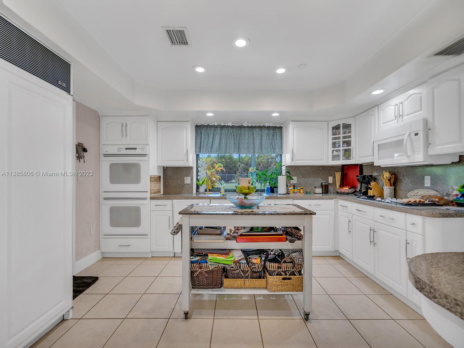 14900 Southwest 250th Street Homestead, FL 33032 - Photo 10 of 34 a kitchen with stainless steel appliances a stove a sink and a refrigerator
