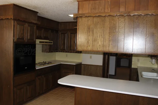 a kitchen with a refrigerator and cabinets