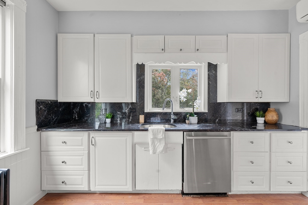 29 Garnet Road Boston, MA 02132 - Photo 15 of 42 a kitchen with stainless steel appliances granite countertop a stove a sink and a microwave