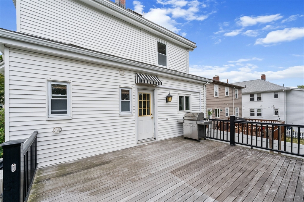 29 Garnet Road Boston, MA 02132 - Photo 19 of 42 a view of a house with a wooden deck