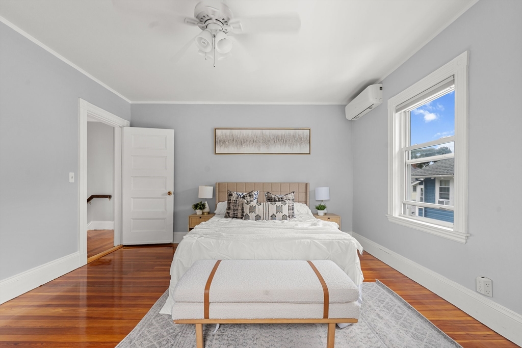 29 Garnet Road Boston, MA 02132 - Photo 24 of 42 a bedroom with a bed and wooden floor
