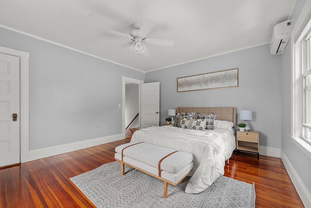 29 Garnet Road Boston, MA 02132 - Photo 25 of 42 a bedroom with a bed and wooden floor