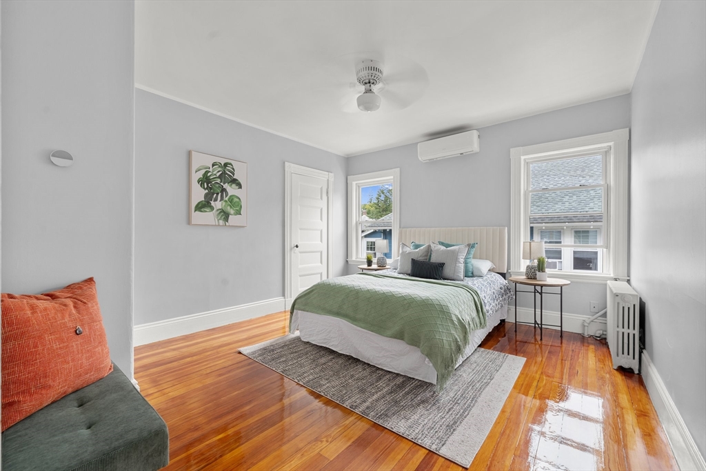 29 Garnet Road Boston, MA 02132 - Photo 27 of 42 a spacious bedroom with a bed wooden floor and window