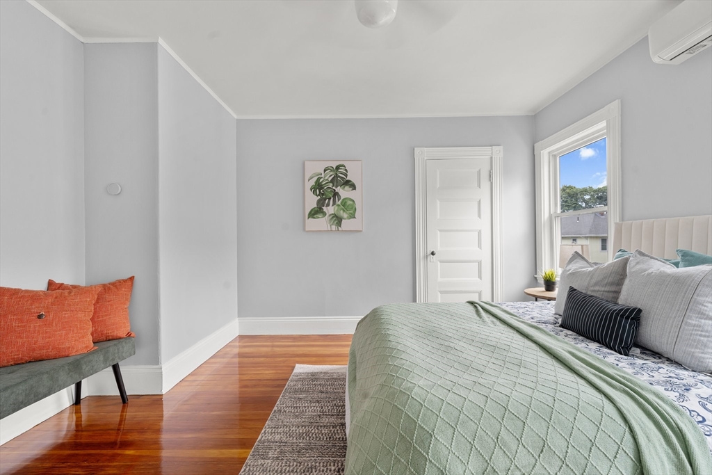 29 Garnet Road Boston, MA 02132 - Photo 28 of 42 a bedroom with a bed and wooden floor