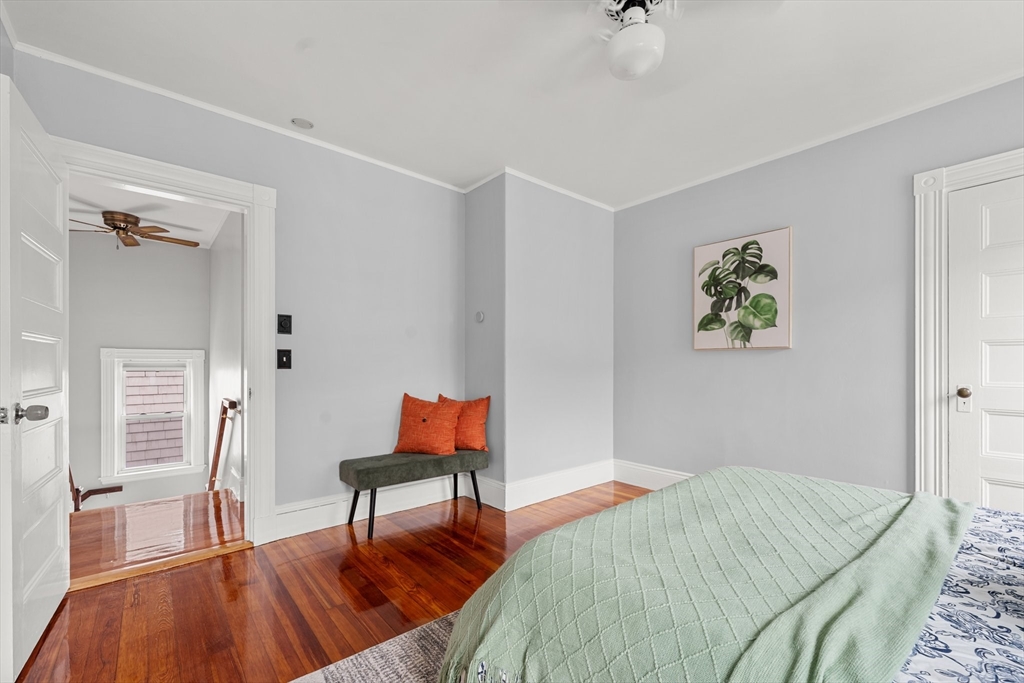 29 Garnet Road Boston, MA 02132 - Photo 29 of 42 a bedroom with a bed and a chandelier