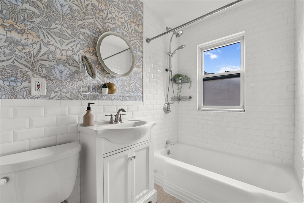 29 Garnet Road Boston, MA 02132 - Photo 33 of 42 a bathroom with a sink mirror and a bathtub