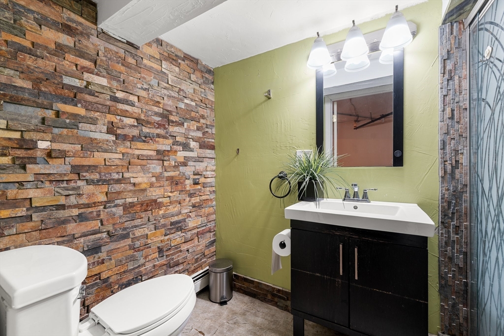 29 Garnet Road Boston, MA 02132 - Photo 35 of 42 a bathroom with a sink a toilet and mirror