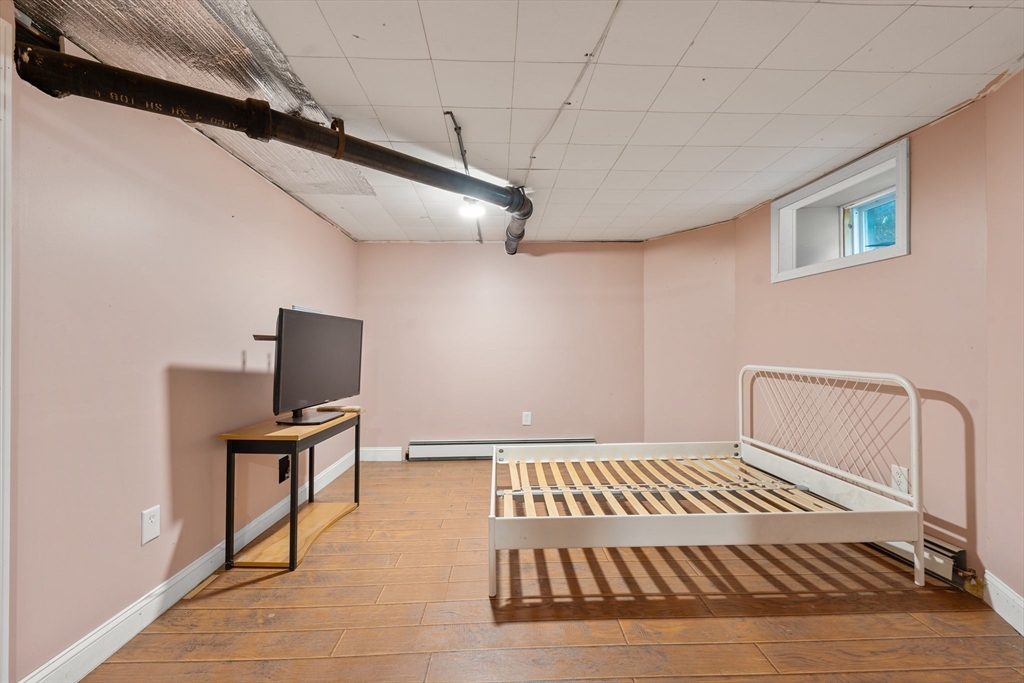 29 Garnet Road Boston, MA 02132 - Photo 37 of 42 a bedroom with a bed and furniture