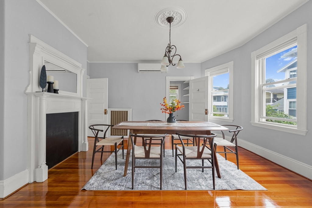 29 Garnet Road Boston, MA 02132 - Photo 10 of 42 a dining room with furniture a chandelier and wooden floor