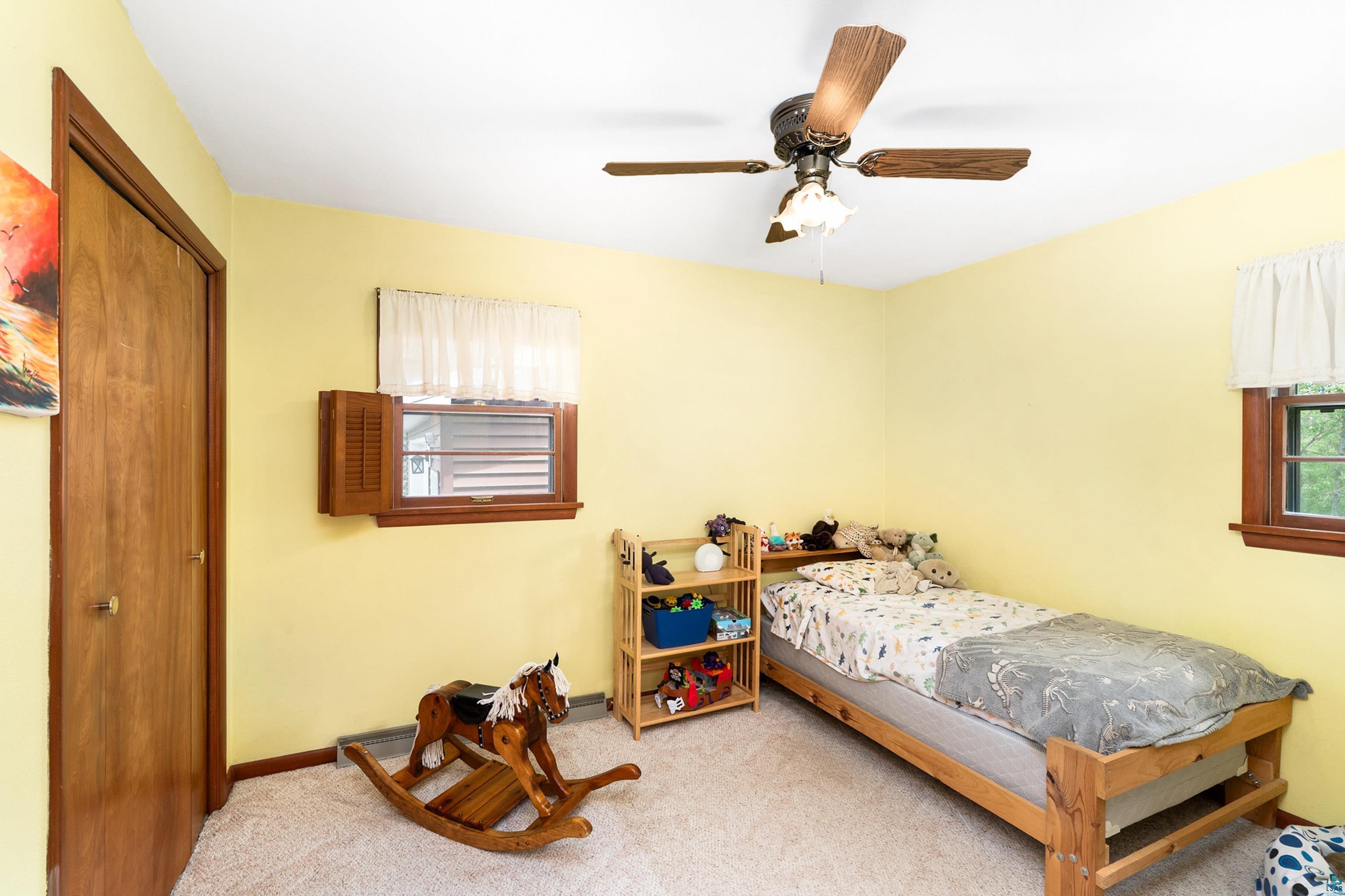 4808 Midway Road Duluth, MN 55811 - Photo 26 of 57 Carpeted room featuring a ceiling fan, a window with wood trim, and a built-in air conditioning unit